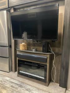 a large flat screen tv on a entertainment center at Downtown Dade City Glamper in Dade City +5 photos