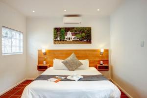a bedroom with a large white bed in a room at Albourne Guesthouse in Somerset West +52 photos
