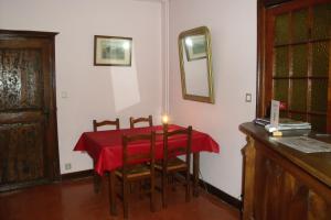 a dining room with a table with a candle on it at Maison d'Hote le Relais de morville in Fresnes