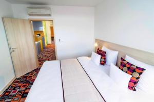 Posteľ alebo postele v izbe v ubytovaní Hotel Metropol