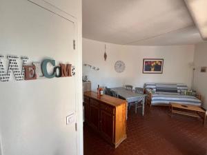 a room with two beds and a desk in it at Villa front de mer, plage nature in Torreilles