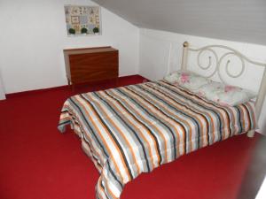 a bedroom with a bed and a dresser in it at Austria Hostel & Pousada in Blumenau