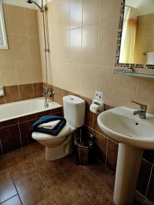 a bathroom with a toilet and a sink at The Brightstay Paphos, 2 bed apt, Paphos Riviera, Universal in Paphos City