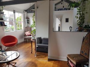a living room with a couch and a table at Beautiful City Centre Apartment with Cathedral View in St. Albans