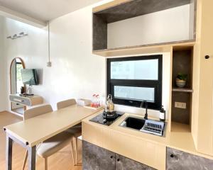 a kitchen with a sink and a window at Sribudaya Resort in Payaarp