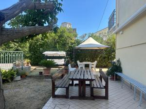 a picnic table and an umbrella on a patio at Pensione Vagnozzi in Grottammare