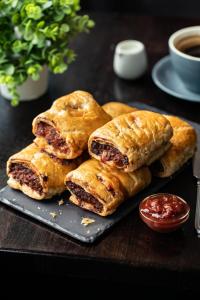 a group of pastries on a black plate with sauce at Rooms at The Marine in Ballybunion +29 photos