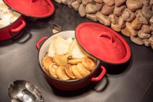 a pot of food sitting on top of a stove at Pytloun Wellness Hotel Harrachov in Harrachov