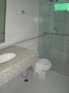a bathroom with a shower and a toilet and a sink at Hotel Elite 1 in Nossa Senhora dos Milagres