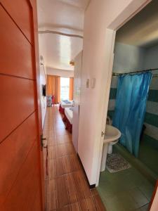 a hallway with a bathroom with a sink and a toilet at Islandview Whitehouse - Camotes in Esperanza +23 photos