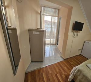 an empty room with a refrigerator and a window at Imeri Hotel in Ureki