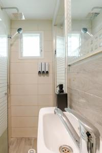 a bathroom with a sink and a shower at Haifa Hadar Urban Apartment in Haifa +37 photos