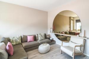 a living room with a couch and a mirror at Forest View Hideaway in Braşov