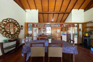 a dining room with a table with chairs and a mirror at Nataka Green in Kopo 2
