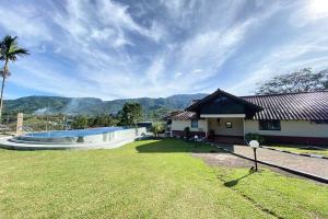 a house with a large yard with a swimming pool at Nataka Green in Kopo 2