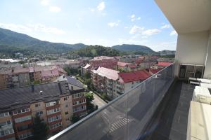 a balcony with a view of a city at Forest View Hideaway in Braşov