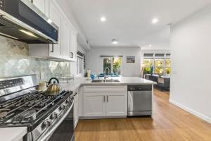 a kitchen with white cabinets and a stove top oven at Luxurious 4BR in prime LA location with great view in Los Angeles
