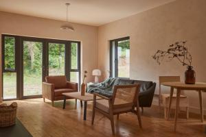 un salon avec un canapé, une table et des chaises dans l'établissement Yarn - Romy Deluxe Apartment, à Ballycastle