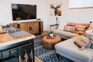 a living room with a couch and a tv at Modern Missoula Bungalow in Missoula