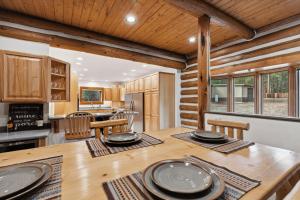 a kitchen and dining room with a wooden table at Mountain Escape Lodge in Victor