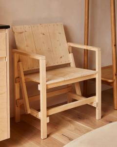 a wooden chair sitting on top of a wooden floor at Yarn - Elmo Deluxe Suite in Ballycastle