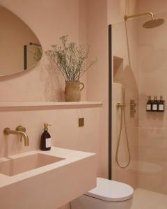 a bathroom with a shower and a sink and a toilet at Yarn - Milo Deluxe King Suite in Ballycastle
