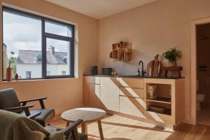 a kitchen with a counter and a window at Yarn - Milo Deluxe King Suite in Ballycastle