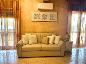 a couch sitting in a living room with windows at Casa Noemi in Sperlonga