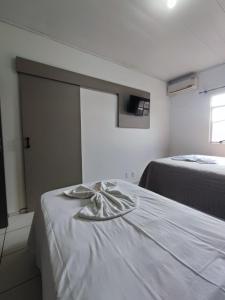 Postel nebo postele na pokoji v ubytování PORTAL PARQUE HOTEL