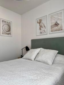 a bedroom with a bed and three pictures on the wall at Air-conditioned Elisa Apartment with spacious sunroof lounge and swimming pool in San Javier +53 photos
