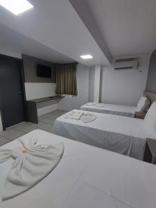 Postel nebo postele na pokoji v ubytování PORTAL PARQUE HOTEL
