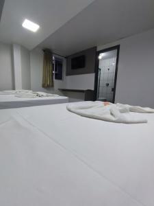 Postel nebo postele na pokoji v ubytování PORTAL PARQUE HOTEL