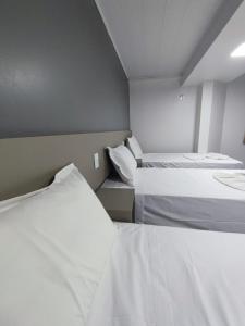 Postel nebo postele na pokoji v ubytování PORTAL PARQUE HOTEL