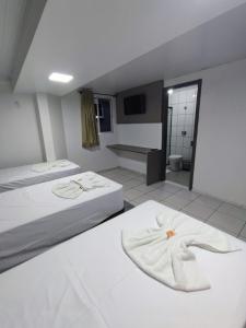 Postel nebo postele na pokoji v ubytování PORTAL PARQUE HOTEL