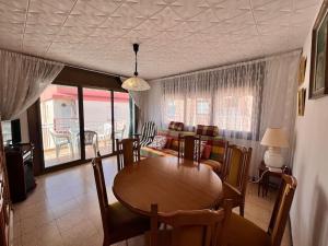 a living room with a table and a couch at Costa Cunit in Cunit