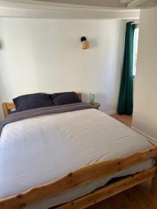 a bedroom with a bed with a wooden frame at Authentique Lavallois T3 au cœur du vieux Laval in Laval