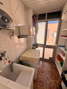 a small kitchen with a sink and a window at Costa Cunit in Cunit +23 photos