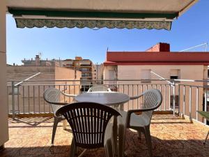 a white table and chairs on a balcony at Costa Cunit in Cunit