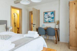 a bedroom with a bed and a table and chairs at Rustic Inn bed and breakfast in Budeşti