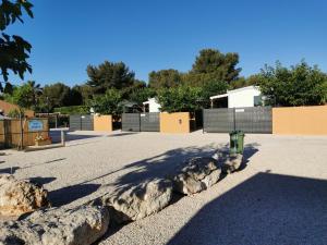 a parking lot with two large rocks and a fire hydrant at tony vacances in Martigues