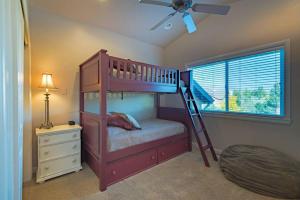 a bedroom with a bunk bed with a ladder at Snowbasin Haven with Hot Tub and Resort Amenities in Huntsville