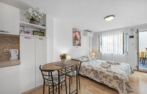 a bedroom with a bed and a table in a room at Amazing Apartment In Vodice in Vodice