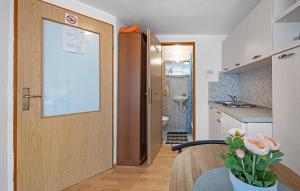 a door to a bathroom with a sink and a toilet at Amazing Apartment In Vodice in Vodice +11 photos