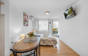 a dining room with a table and a room with a bed at Amazing Apartment In Vodice in Vodice