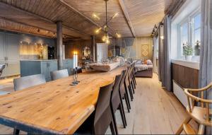 a dining room with a large wooden table and chairs at Awesome Home In Svingvoll With Sauna in Svingvoll