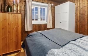 a bedroom with a bed and a window at Awesome Home In Svingvoll With Sauna in Svingvoll