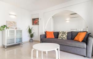 a living room with a couch and a table at Nice Apartment In Fuengirola With Wifi in Fuengirola