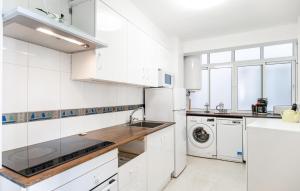 a white kitchen with a sink and a dishwasher at Nice Apartment In Fuengirola With Wifi in Fuengirola