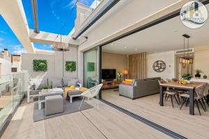 a living room with a table and a dining room at Penthouse Santa Rosalia in Las Casicas