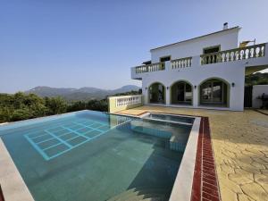 a villa with a swimming pool and a house at Olive Villa in Episkopianá